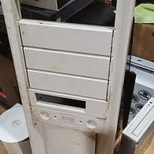 Desktop computer tower opened up, parts being sorted for reuse or recycling