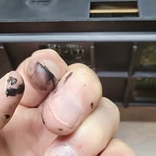 Hands cleaning sticky drive-belt residue from a VCR mechanism