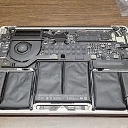 Laptop battery bays exposed during a repair
