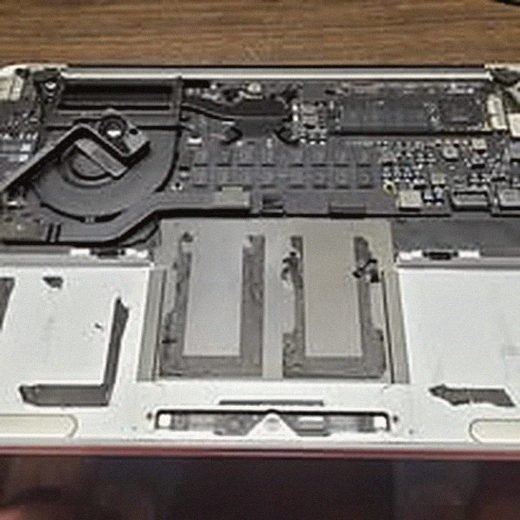 MacBook opened to show its internal logic board and components