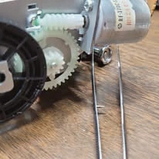 Hands doing precision motor and gear repair work