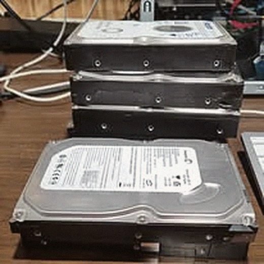 Stacked hard drives pulled and sorted from retired machines